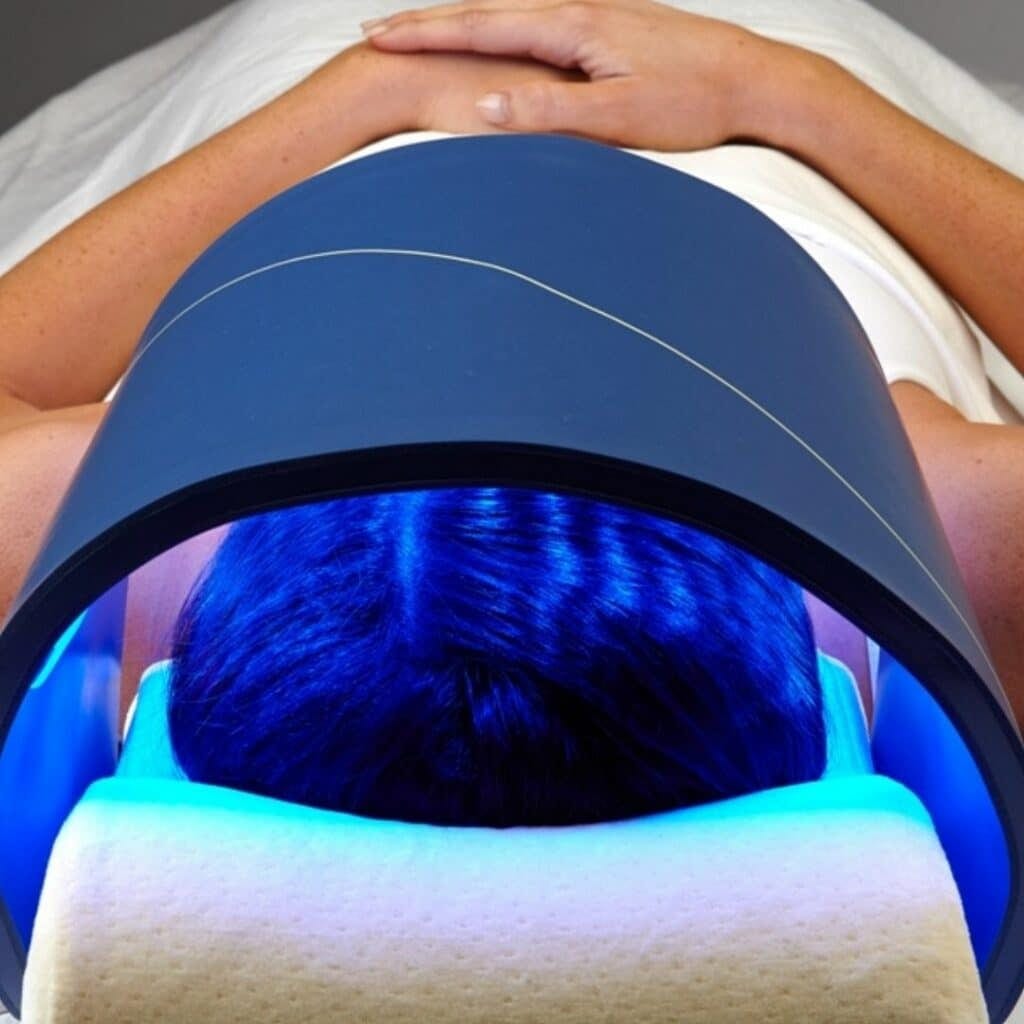 LED light therapy dome in use during a facial