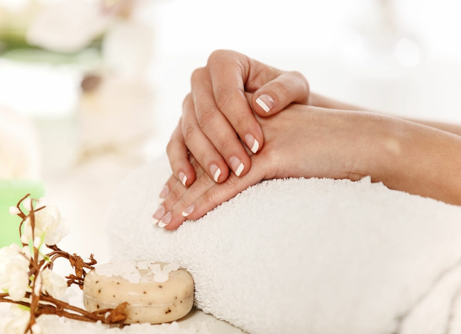 A finished natural manicure resting on a rolled towel