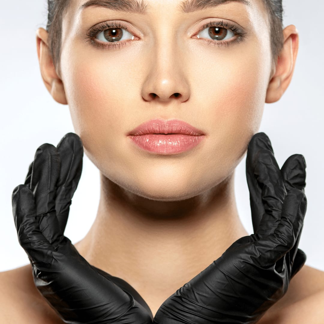 Gloved hands framing the facial structure — lift and contour