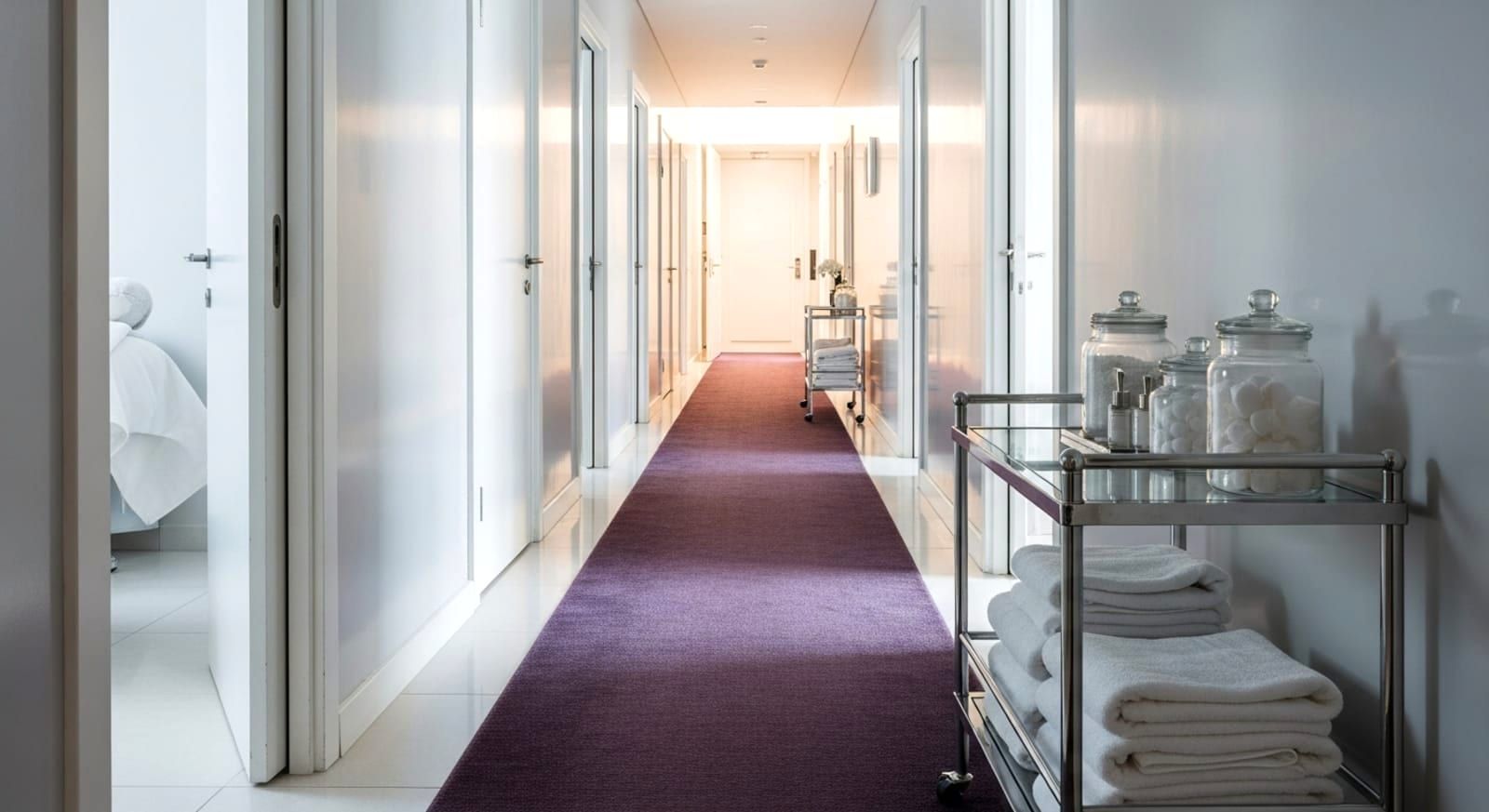 The treatment corridor at Bella Reina Spa — instrument trays and porcelain light